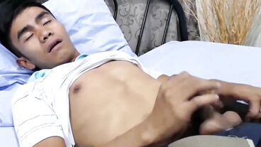 Asian twink plays with his dick and feet in his bedroom